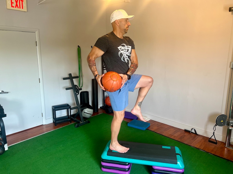 /content/dam/images/golfdigest/fullset/fitness-2024/Gozbekian step-up with med-ball chop 2.jpeg